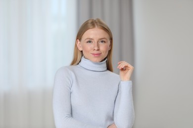 Photo of Portrait of beautiful young woman at home