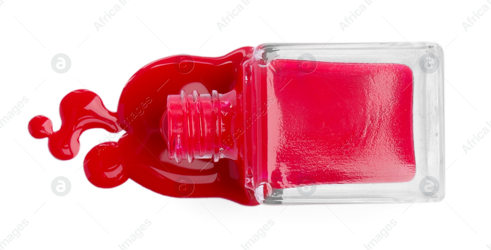 Photo of Bottle and spilled red nail polish isolated on white, top view