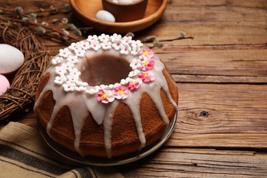 Delicious Easter cake decorated with sprinkles on wooden table. Space for text