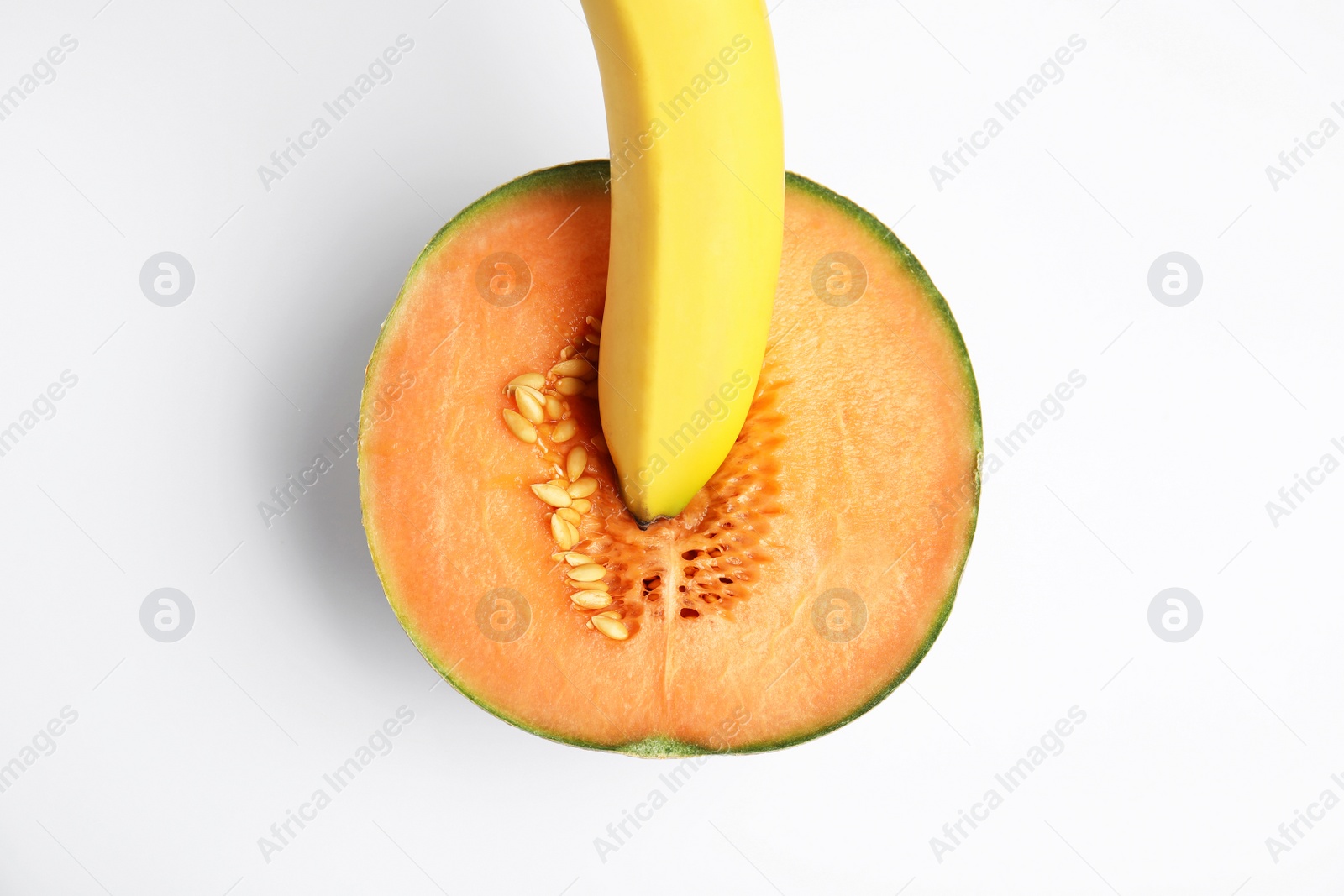 Photo of Fresh melon and banana on white background, top view. Sex concept