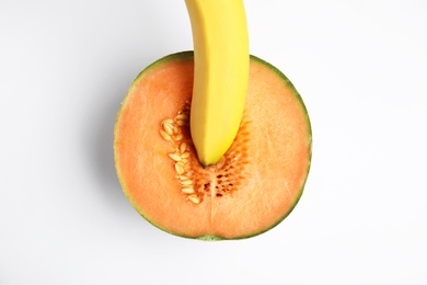 Photo of Fresh melon and banana on white background, top view. Sex concept