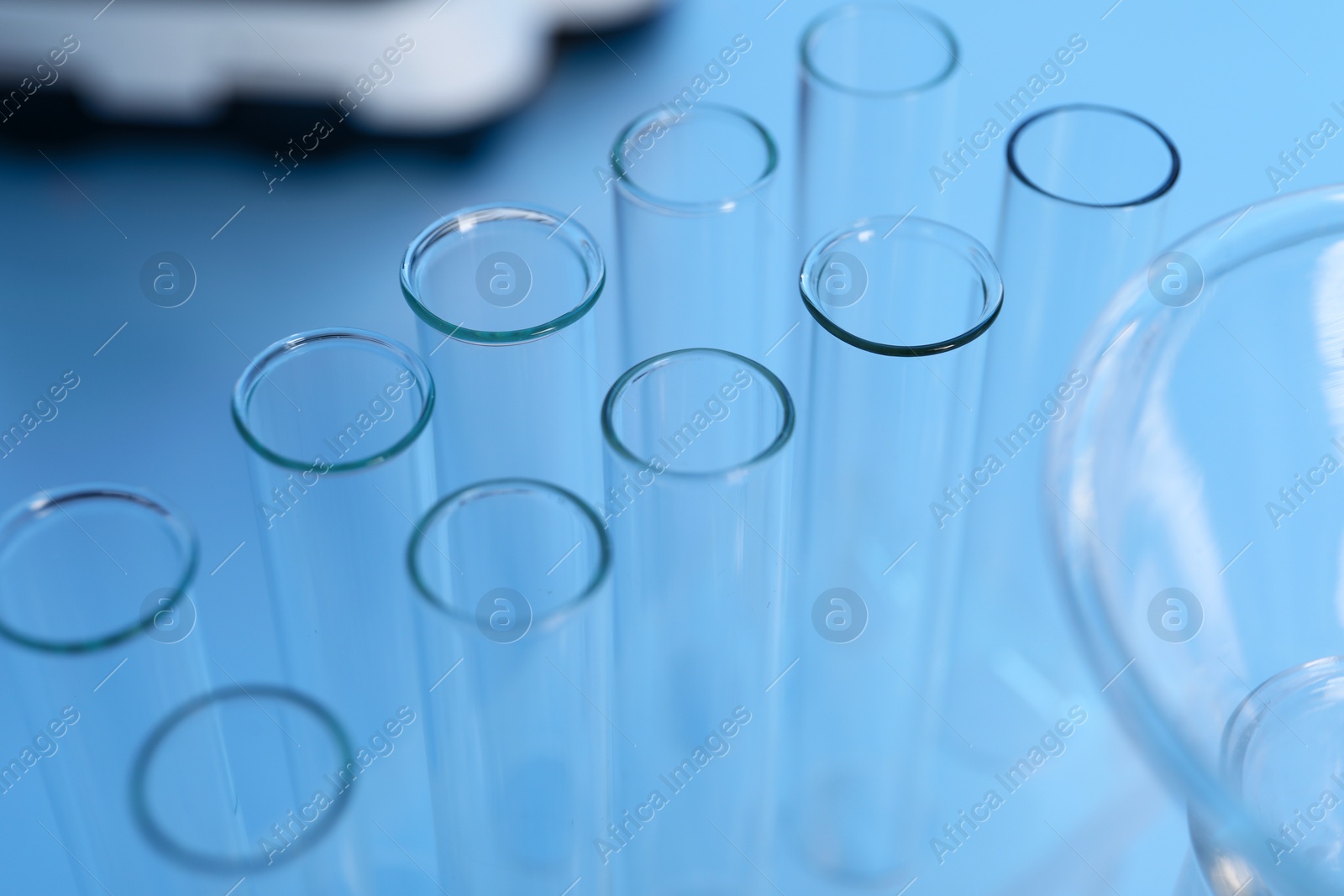 Photo of Laboratory analysis. Glass test tubes on white table indoors, closeup