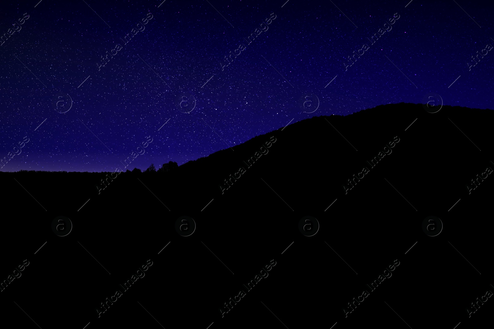 Image of Beautiful view of starry sky over mountains at night