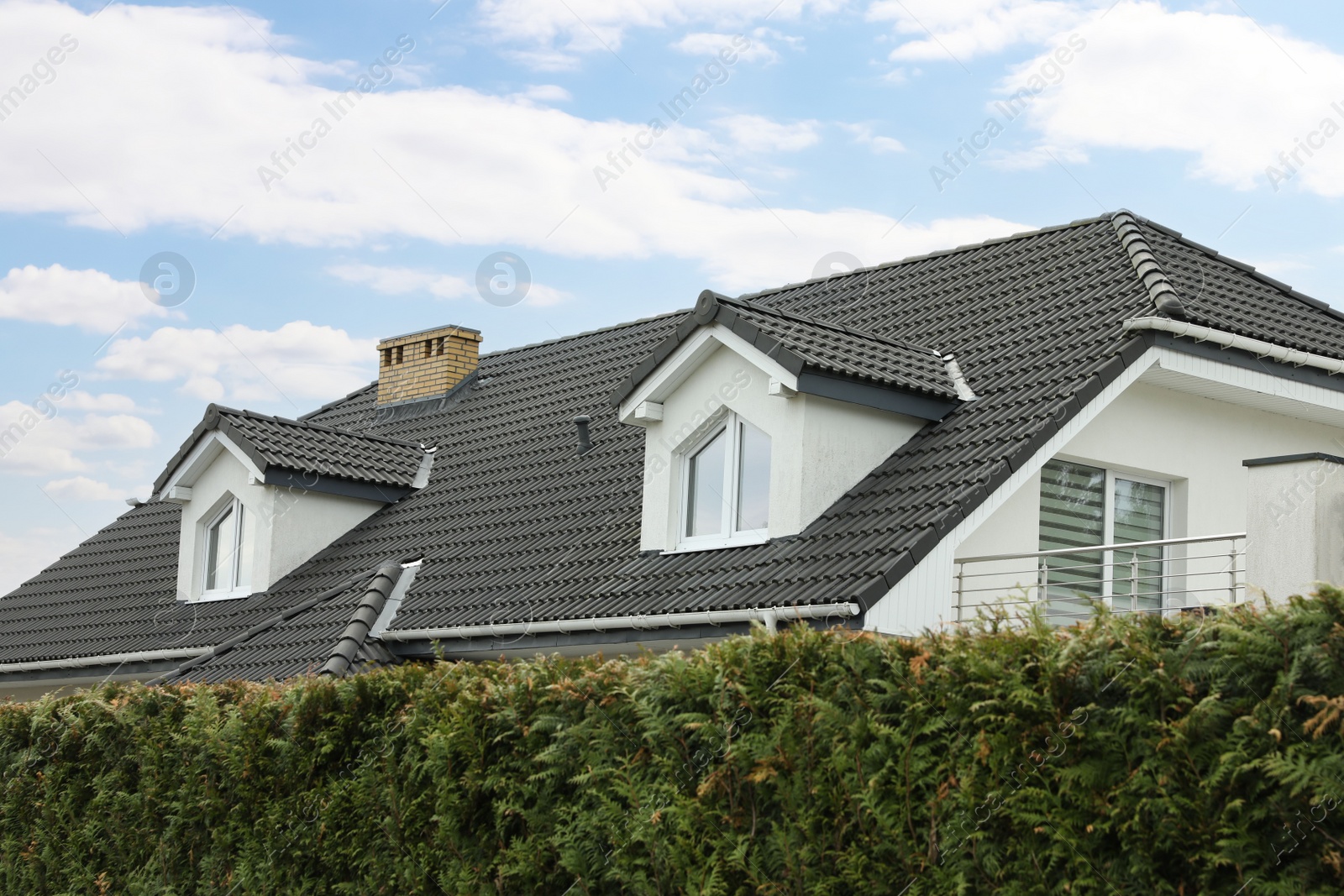 Photo of Modern building with grey roof outdoors on spring day