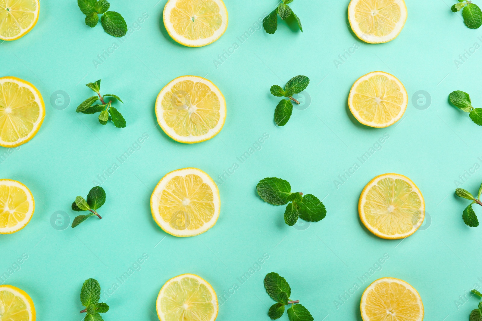 Photo of Lemonade layout with juicy lemon slices and mint on turquoise background, top view