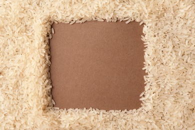 Photo of Frame made with parboiled rice on color background, top view. Space for text