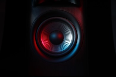 One sound speaker in neon light on black background, closeup