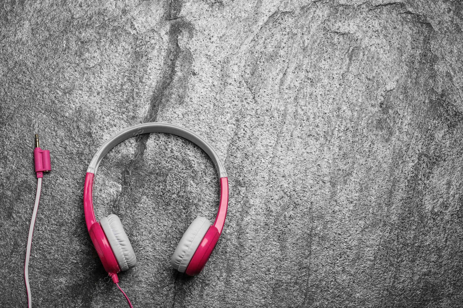 Photo of Stylish headphones on grey background, top view. Space for text