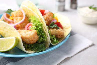 Photo of Yummy fish tacos served on table, closeup