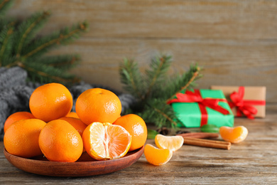 Tasty fresh tangerines on wooden table. Christmas celebration