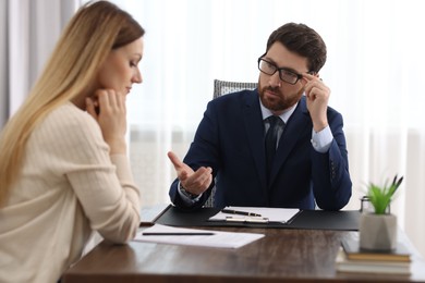 Woman having meeting with lawyer in office, selective focus