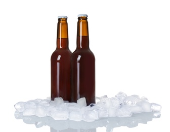 Photo of Bottles of beer and ice cubes on white background