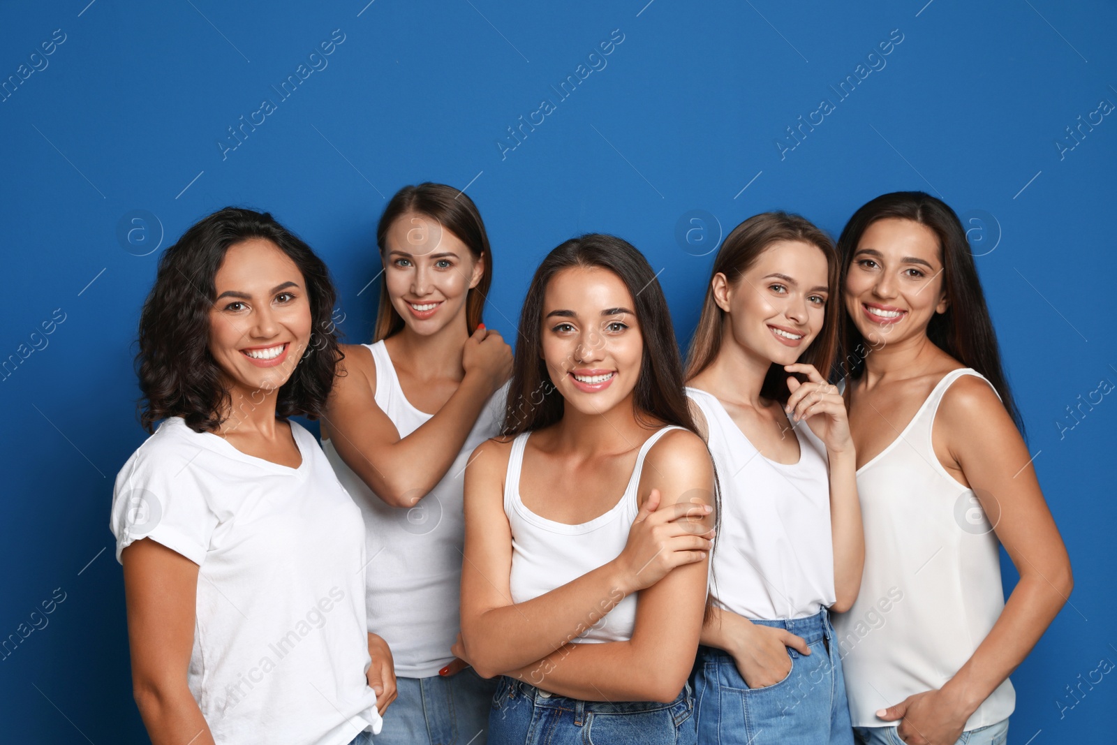 Photo of Happy women on blue background. Girl power concept