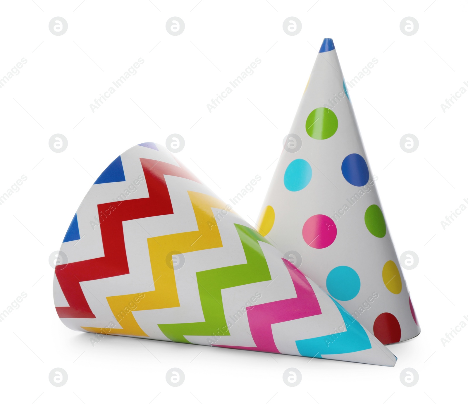 Photo of Bright party hats on white background. Festive accessory