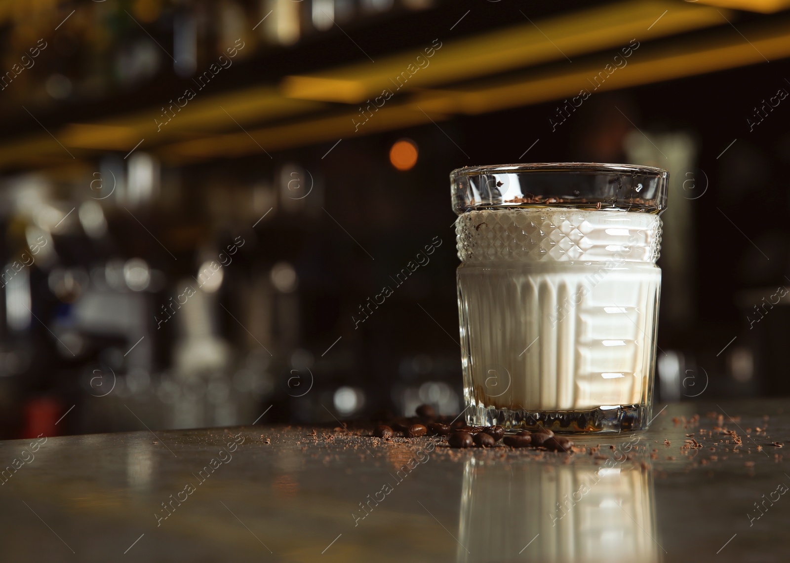 Photo of Fresh alcoholic White Russian cocktail on bar counter. Space for text