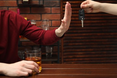 Photo of Drunk man refusing drive car while woman suggesting him keys, closeup. Don't drink and drive concept