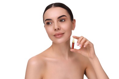 Beautiful young woman holding skincare ampoule on white background