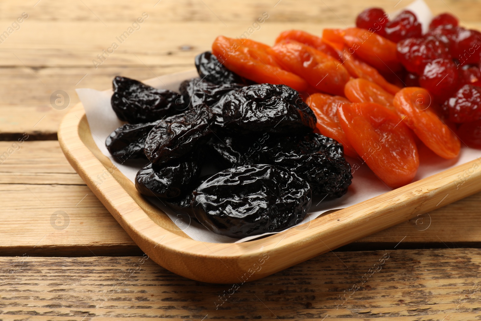 Photo of Delicious dried fruits on wooden table, closeup