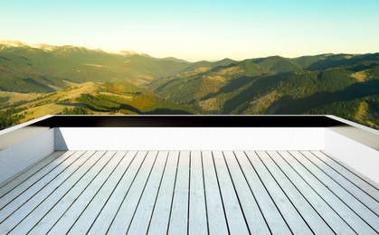 Outdoor wooden terrace revealing picturesque view on mountains in morning