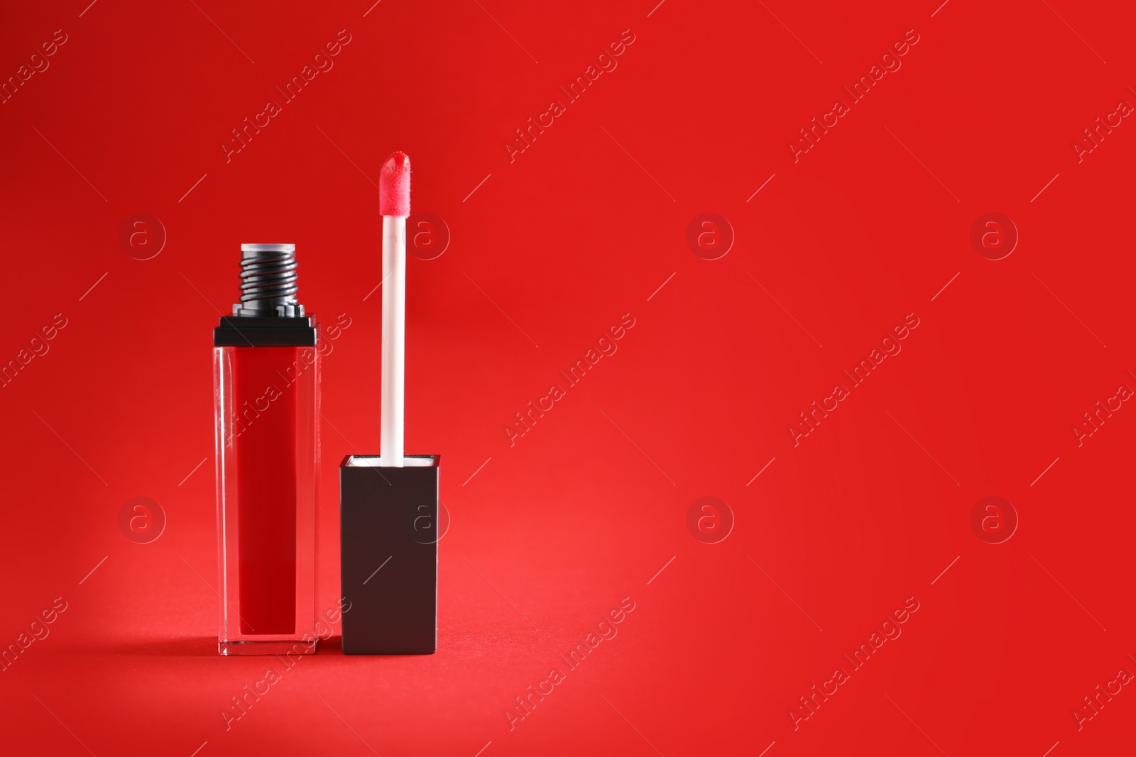 Photo of Applicator with liquid lipstick tube on color background. Space for text