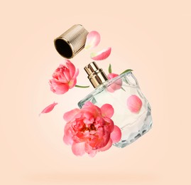 Bottle of perfume and peonies in air on beige background. Flower fragrance
