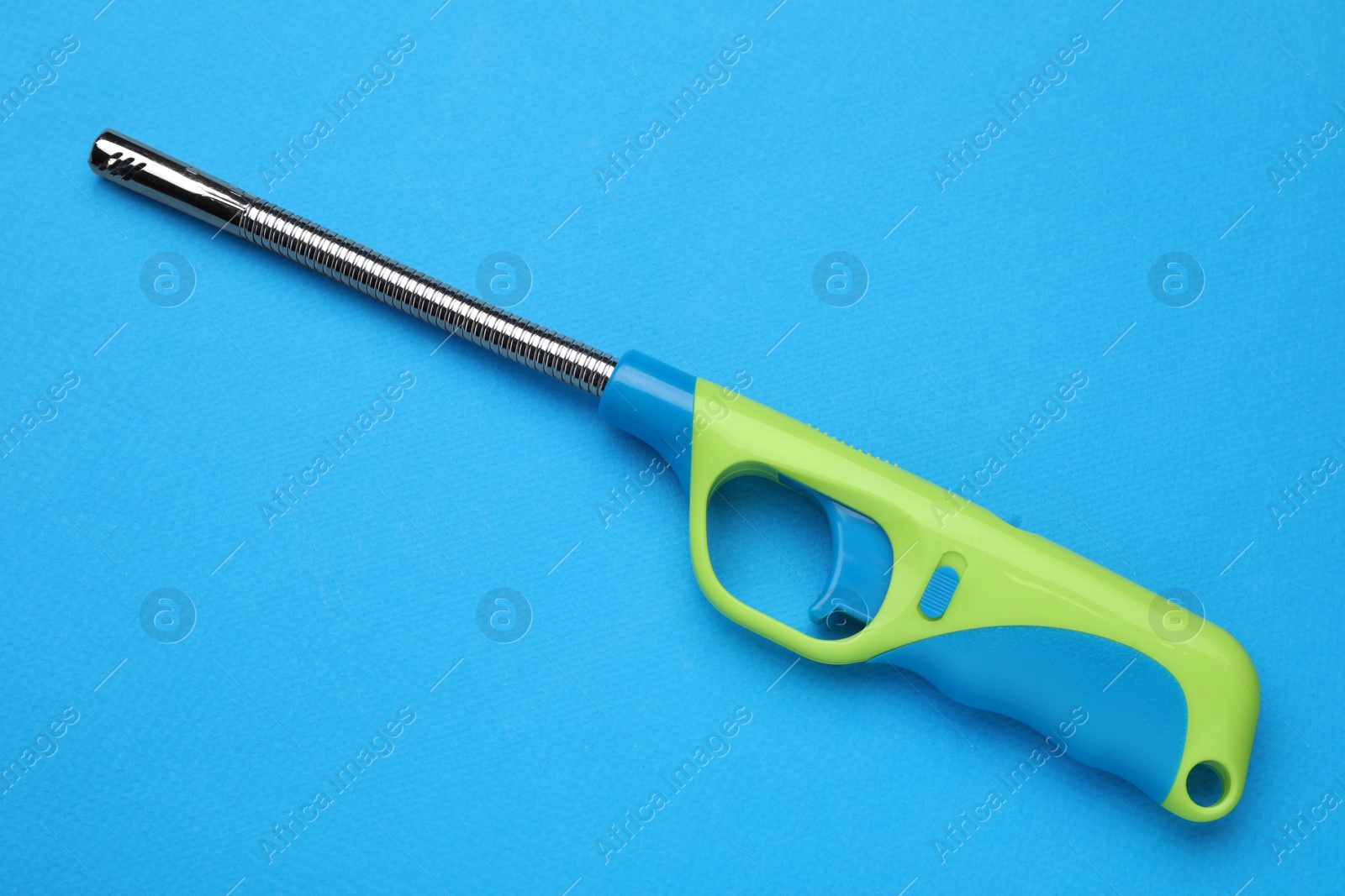 Photo of One gas lighter on blue background, top view