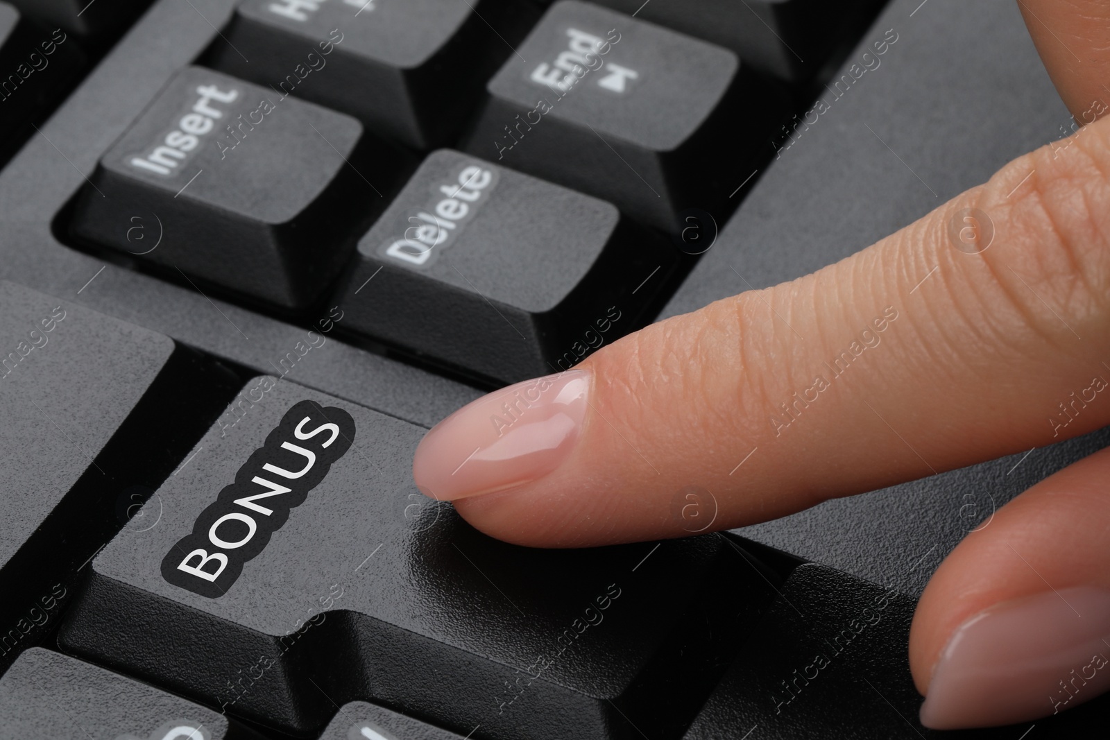 Image of Woman pressing Bonus button on keyboard, closeup