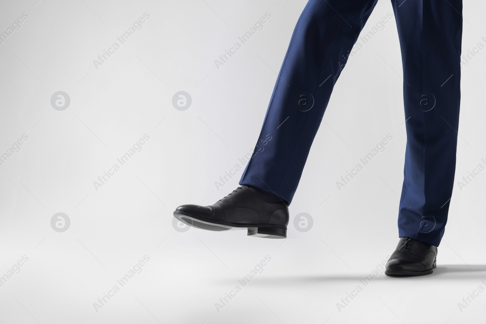 Photo of Businessman in leather shoes on white background, closeup