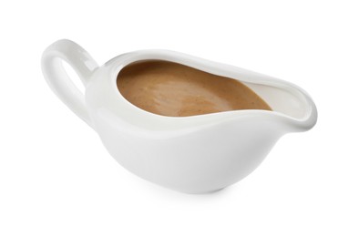 Photo of Delicious turkey gravy in sauce boat isolated on white