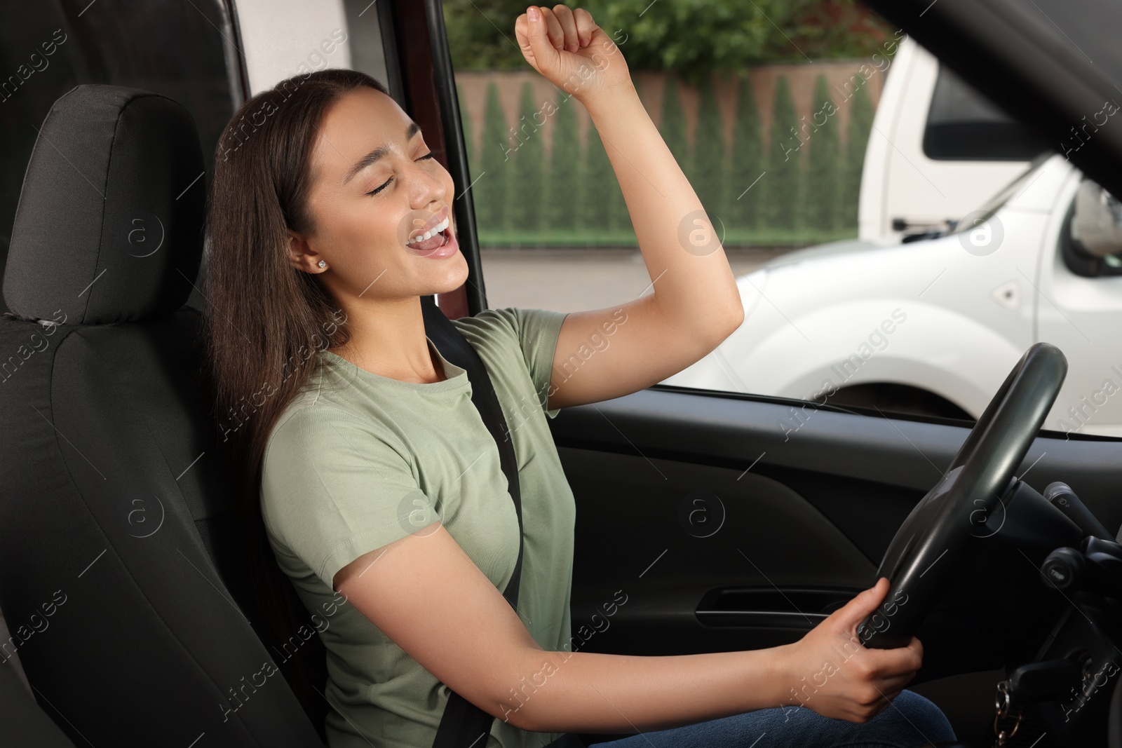 Photo of Listening to radio. Beautiful woman enjoying music in car