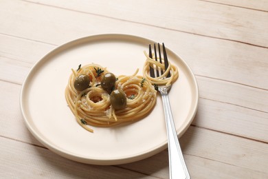 Photo of Heart made of tasty spaghetti, fork, olives and cheese on light wooden table. Space for text