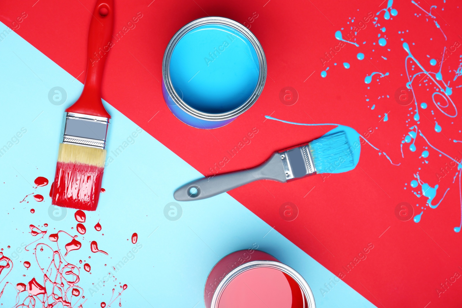 Photo of Flat lay composition with paint cans and brushes on color background