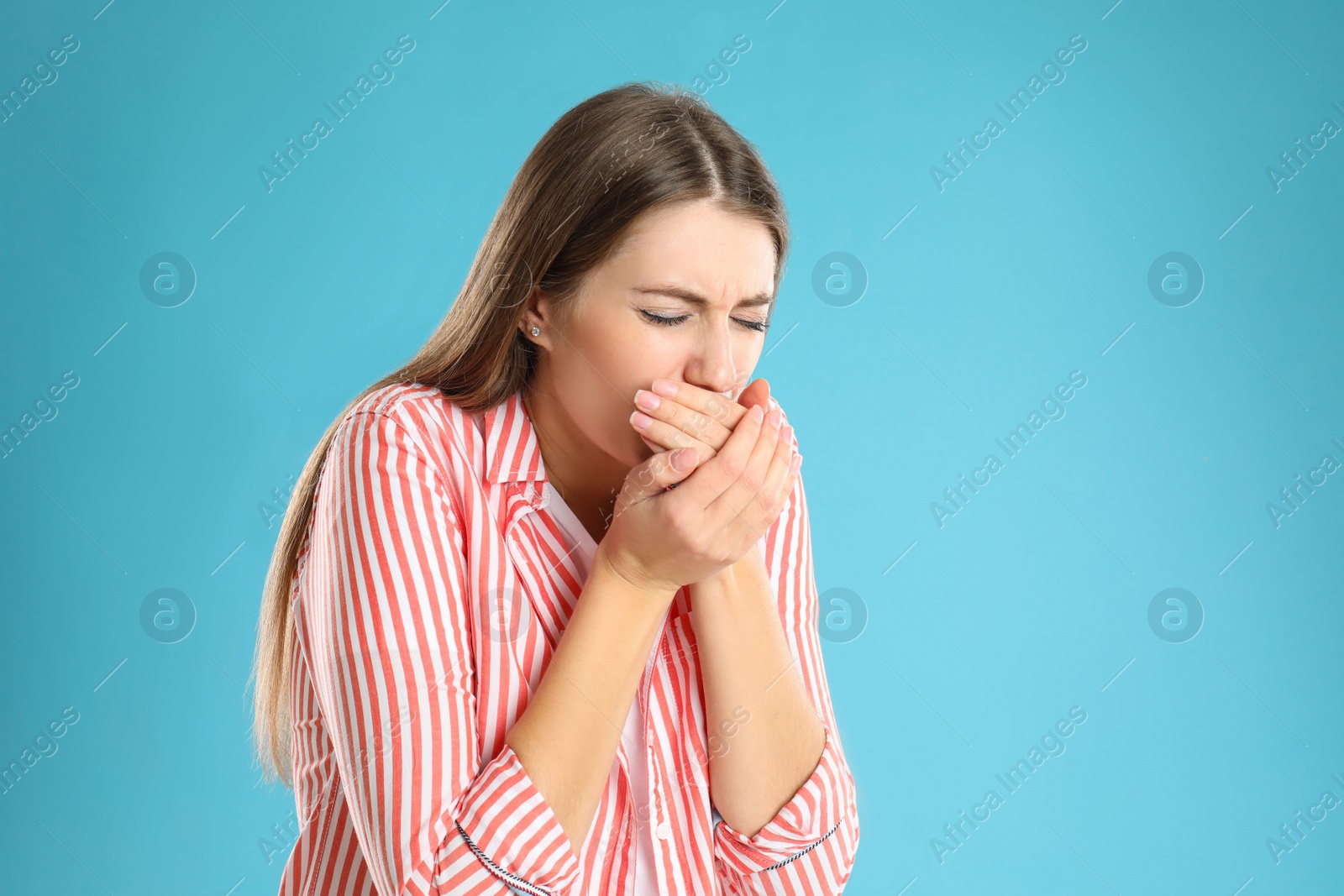 Photo of Woman suffering from nausea on light blue background, space for text. Food poisoning