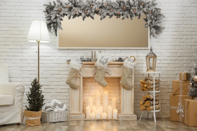 Room interior with mirror over fireplace decorated for Christmas