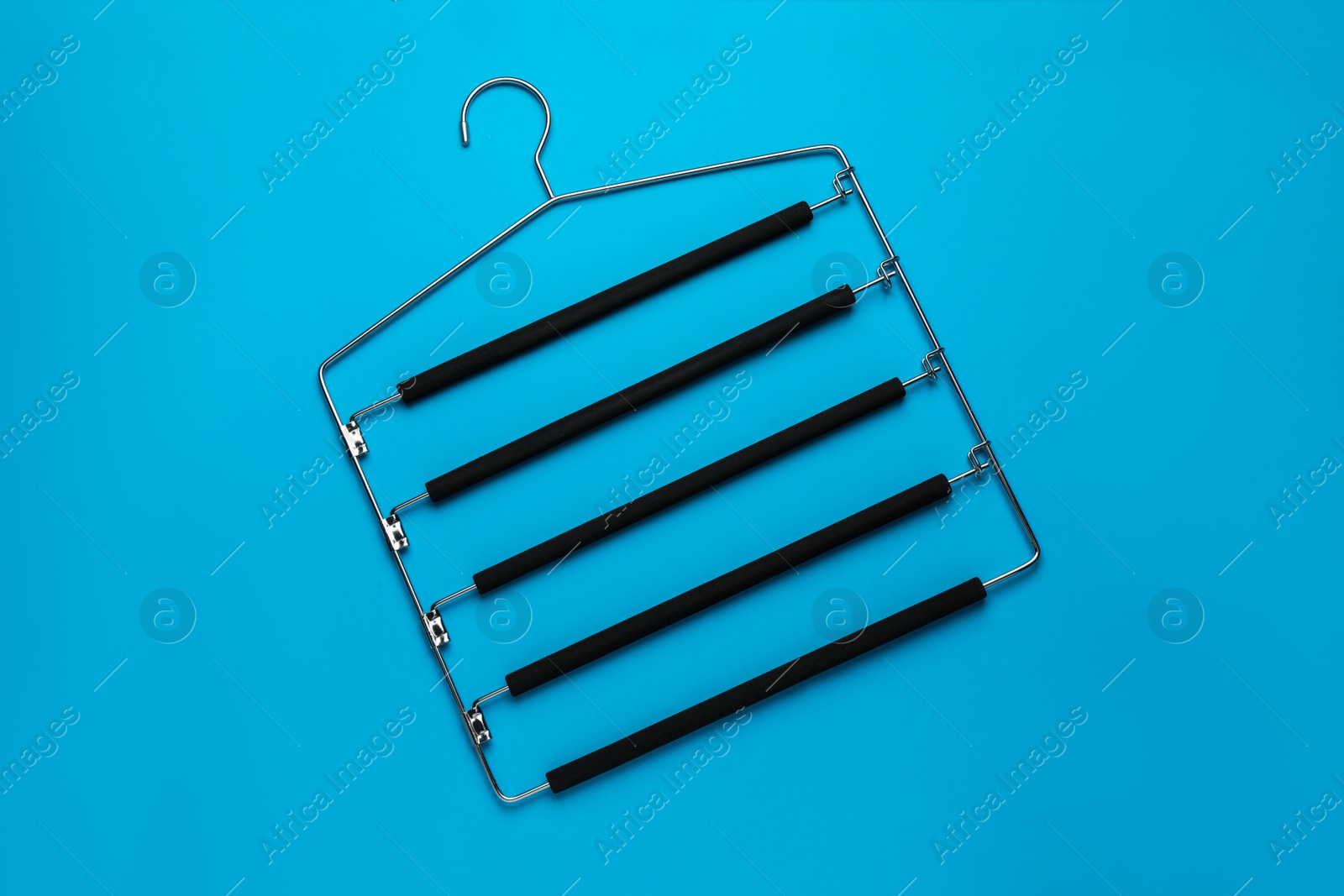 Photo of Empty hanger on light blue background, top view