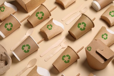 Image of Set of eco friendly food packaging with recycling symbols on beige background