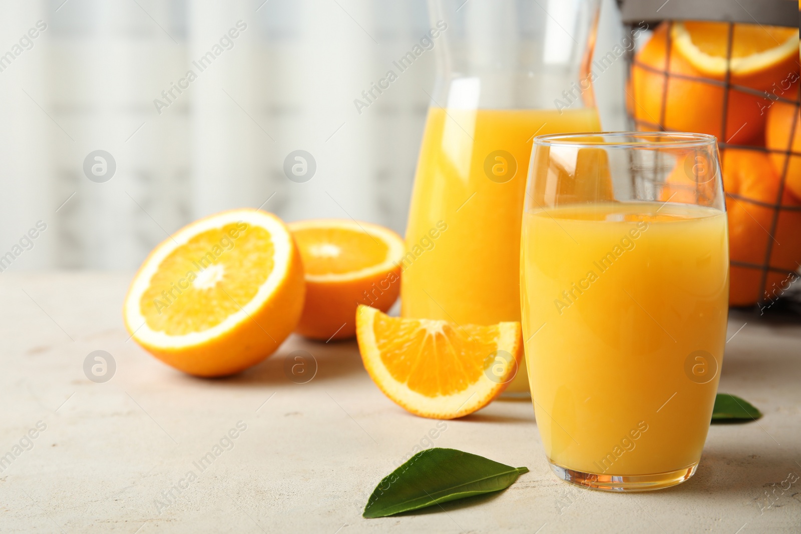 Photo of Composition with orange juice and fresh fruit on table, space for text