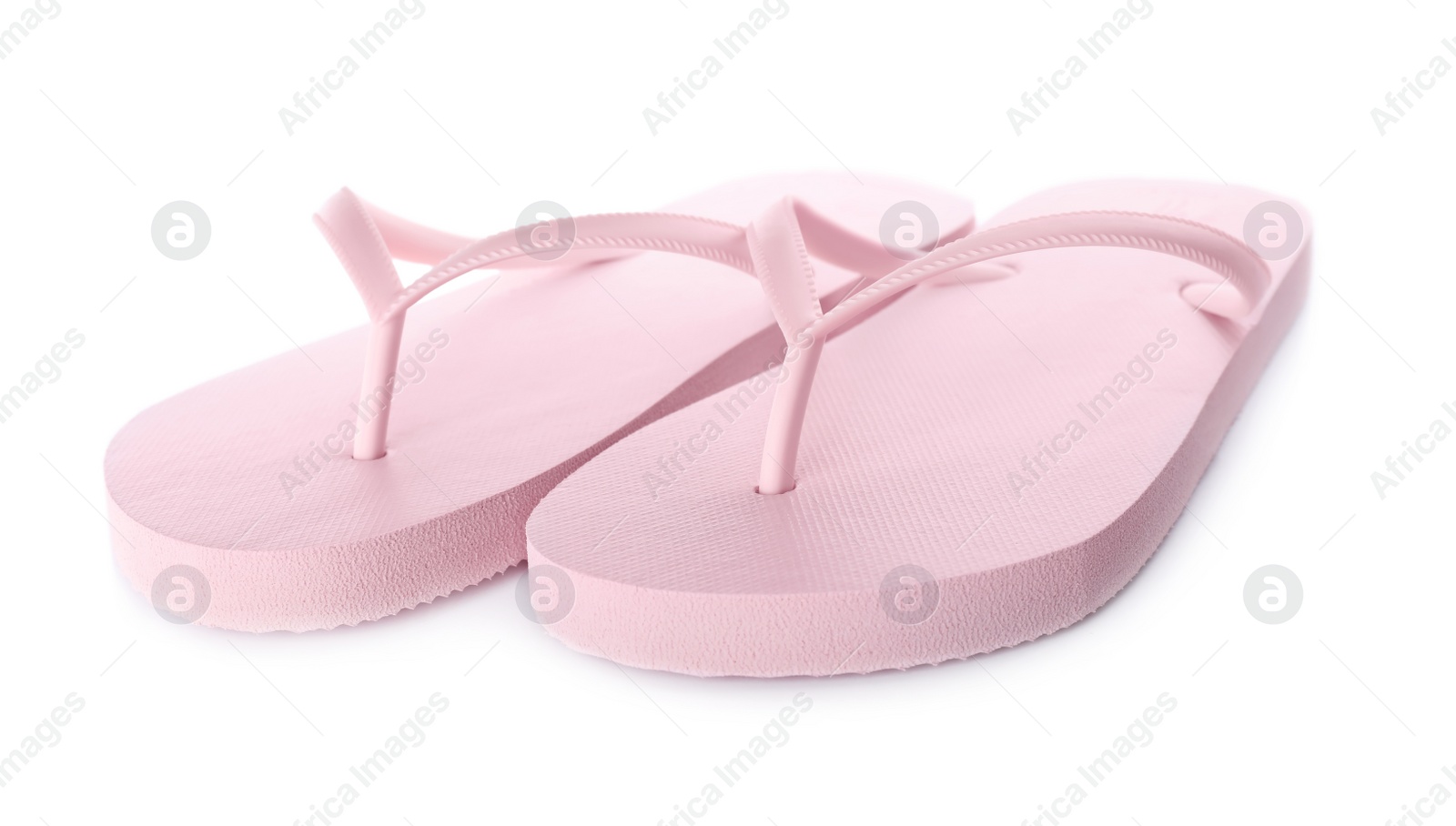 Photo of Light pink flip flops isolated on white. Beach accessory