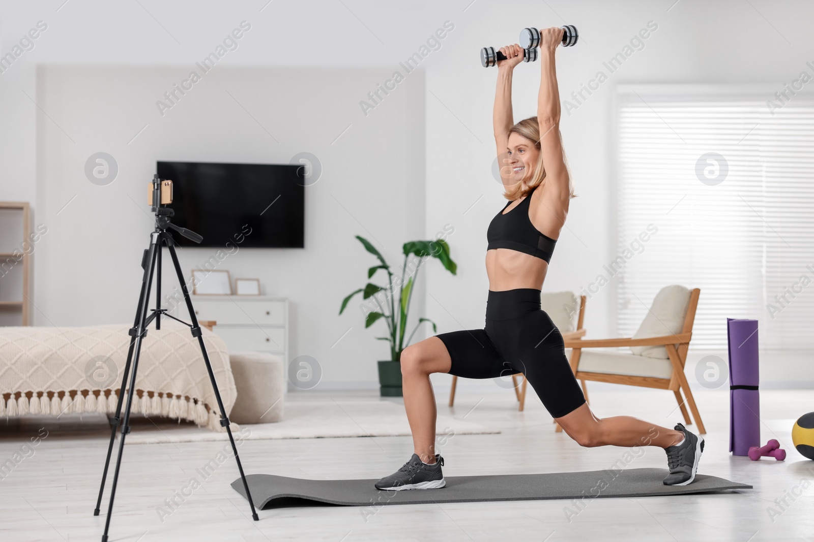 Photo of Fitness trainer recording online classes at home