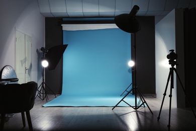 Photo of Modern photo studio interior with professional lighting equipment