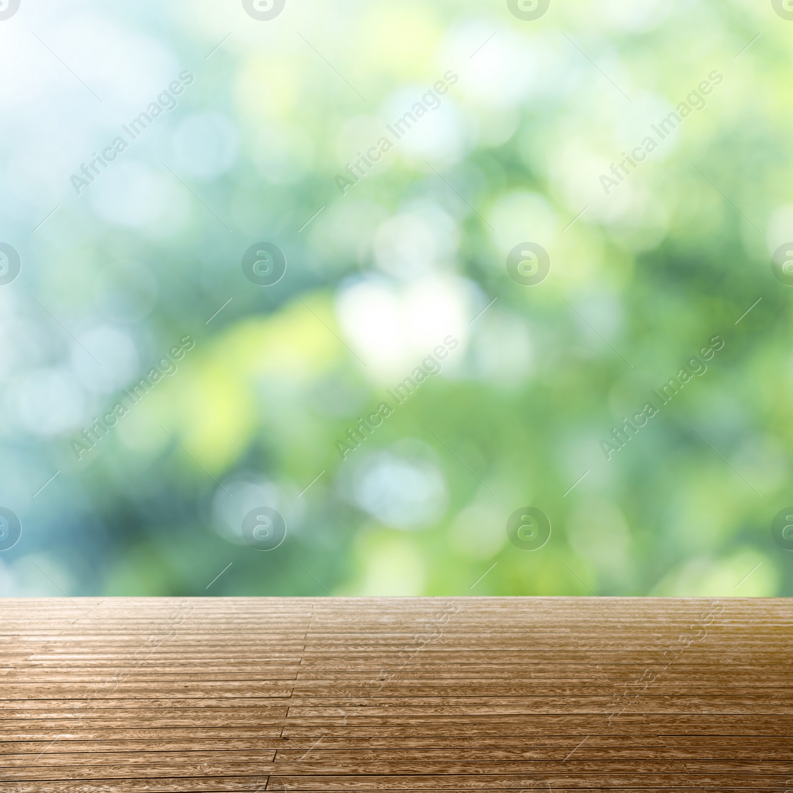 Image of Empty wooden surface against blurred green background. Bokeh effect