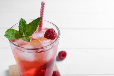 Photo of Delicious raspberry lemonade made with soda water on white background, closeup. Space for text