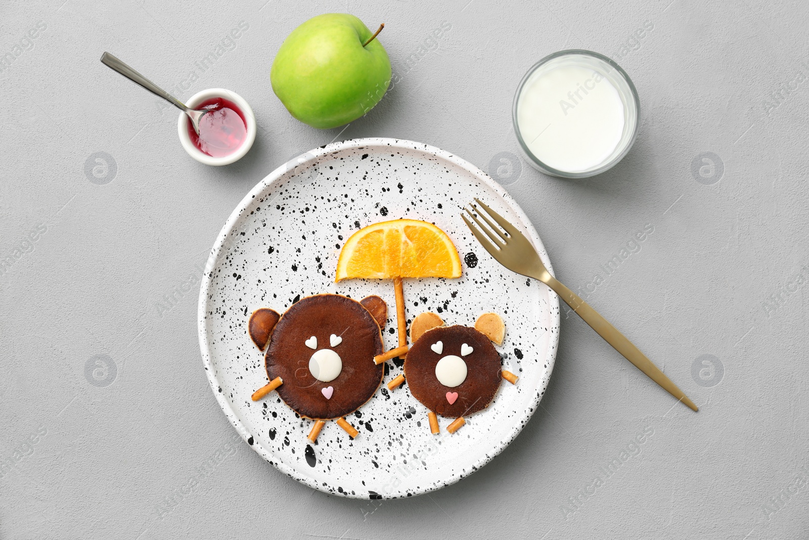 Photo of Flat lay composition with funny chocolate pancakes on grey background. Creative breakfast ideas for kids