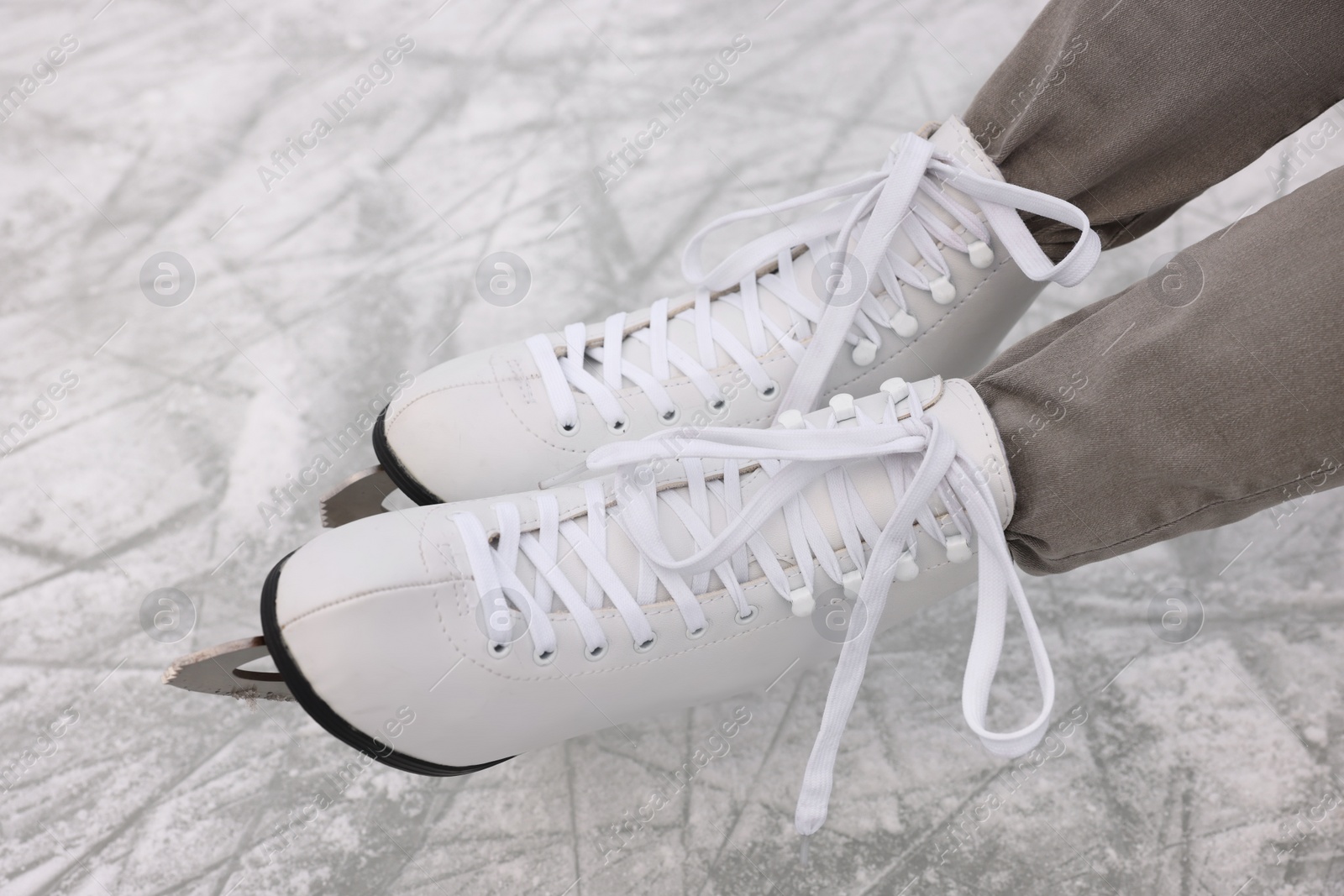 Photo of Woman wearing figure skates on ice, closeup