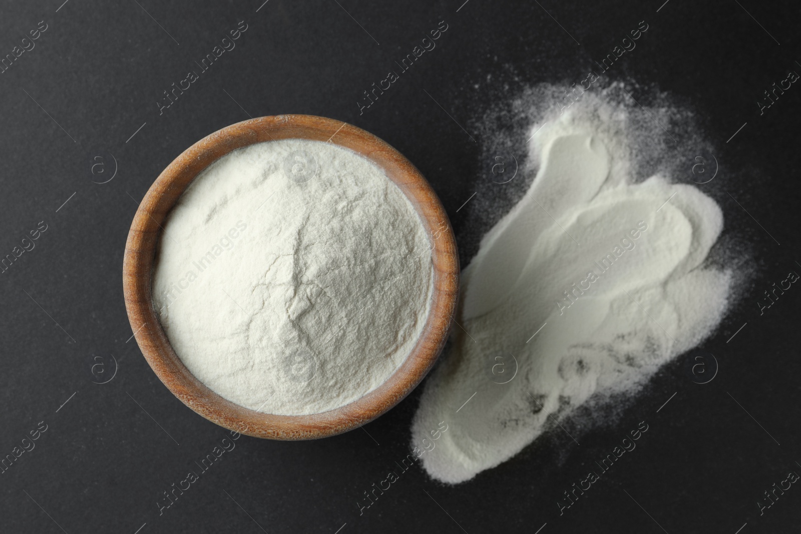 Photo of Bowl of agar-agar powder on black background, flat lay