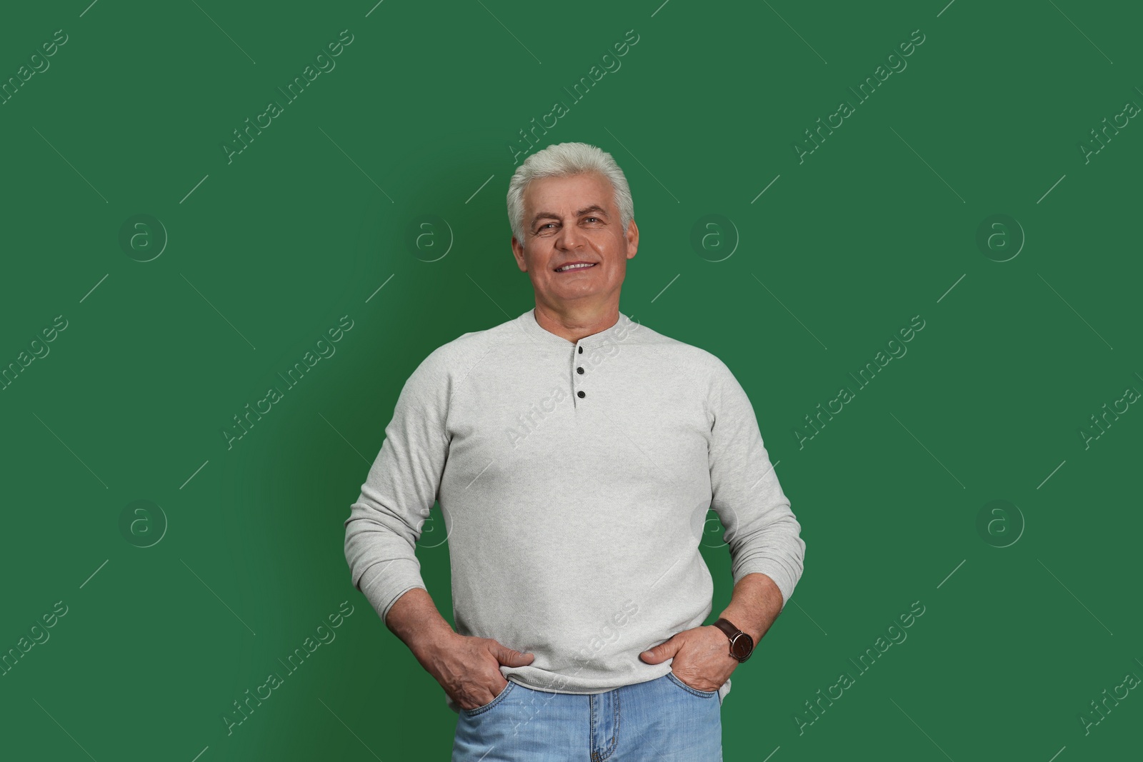 Photo of Portrait of handsome mature man on color background