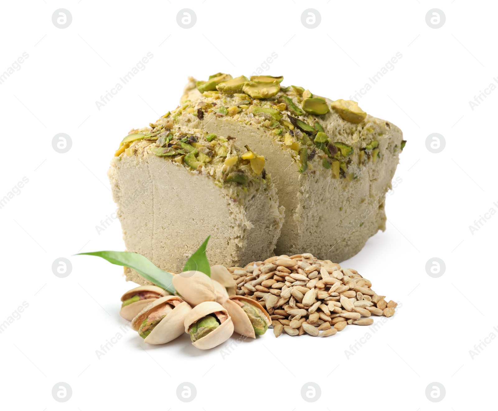 Image of Tasty halva, peeled sunflower seeds, pistachio nuts and green leaves isolated on white