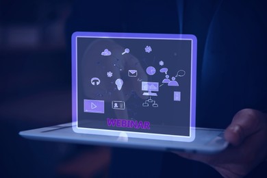 Webinar. Man holding tablet, closeup. Virtual screen with icons over computer