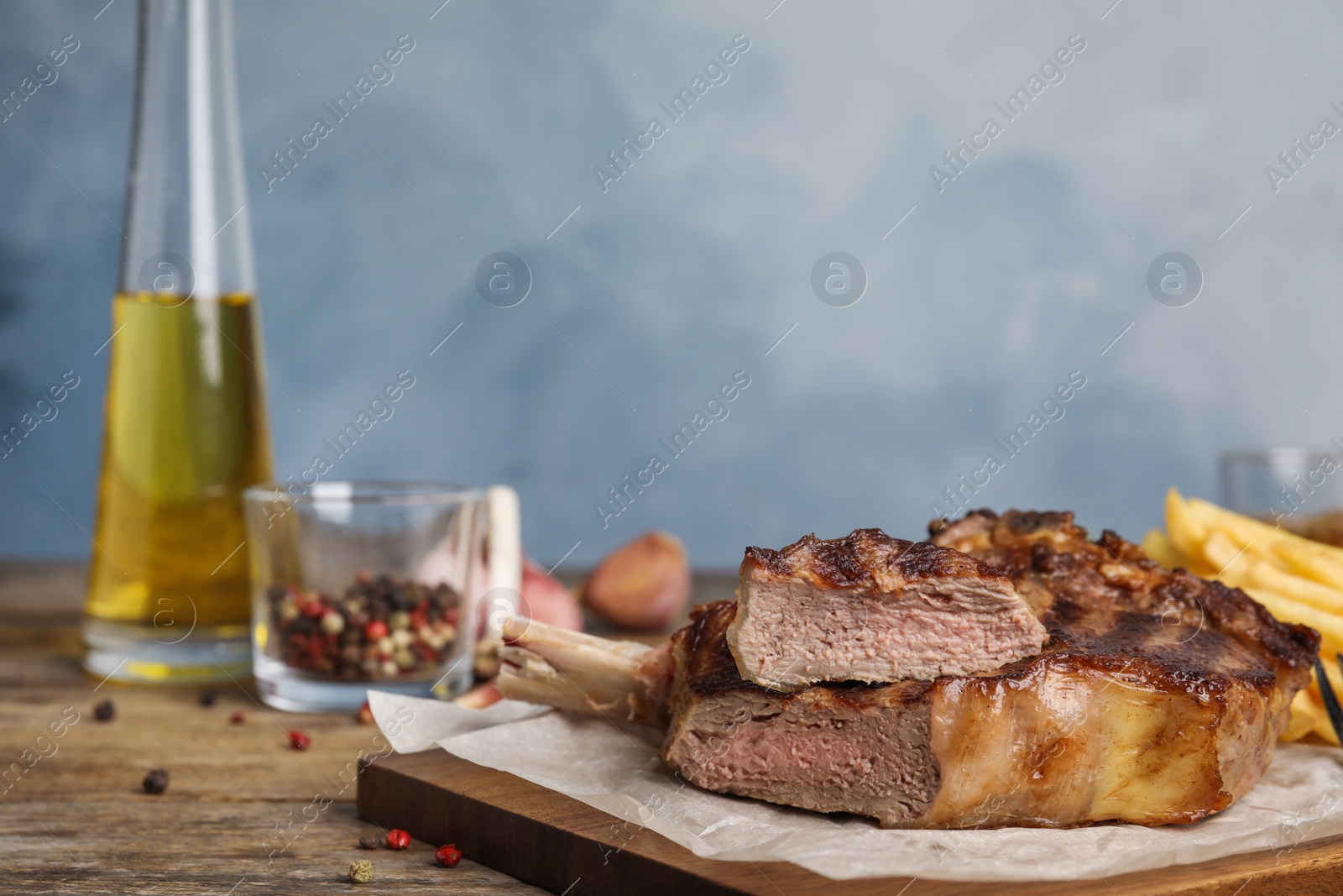 Photo of Tasty grilled beef steak on wooden table, closeup