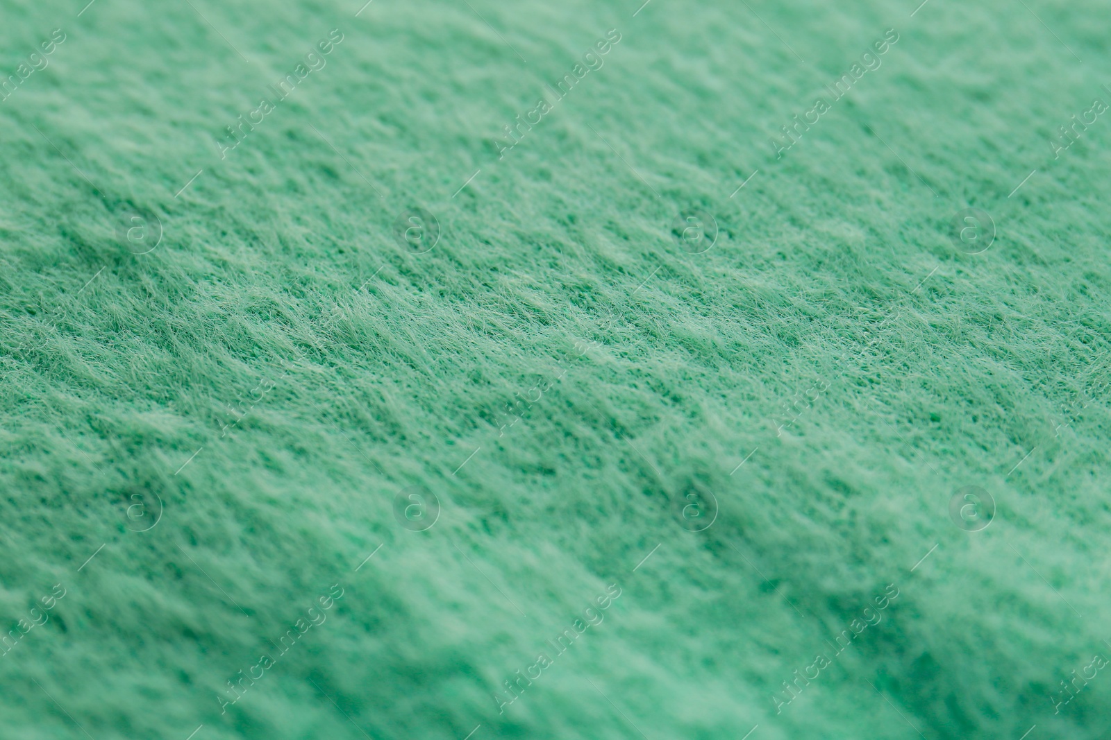 Photo of Beautiful green fabric as background, closeup view